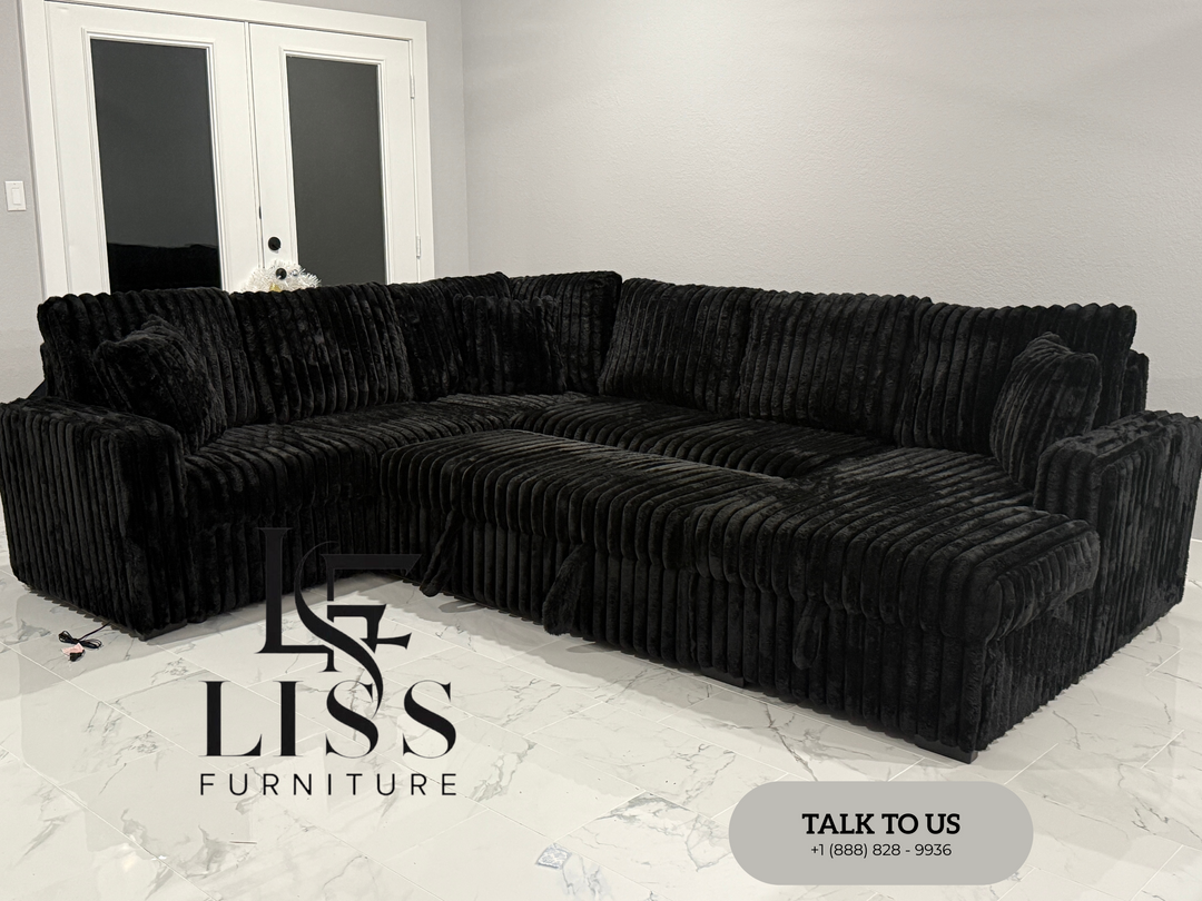 Black sectional sofa in a room with 'Liss Furniture' branding.
